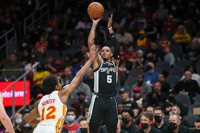 Feb 11, 2022; Atlanta, Georgia, USA; San Antonio Spurs guard Dejounte Murray (5) shoots over Atlanta Hawks forward De'Andre Hunter (12) in the first quarter at State Farm Arena.